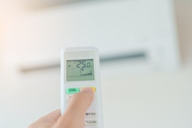 User setting ideal air conditioning temperature for comfort and energy efficiency.