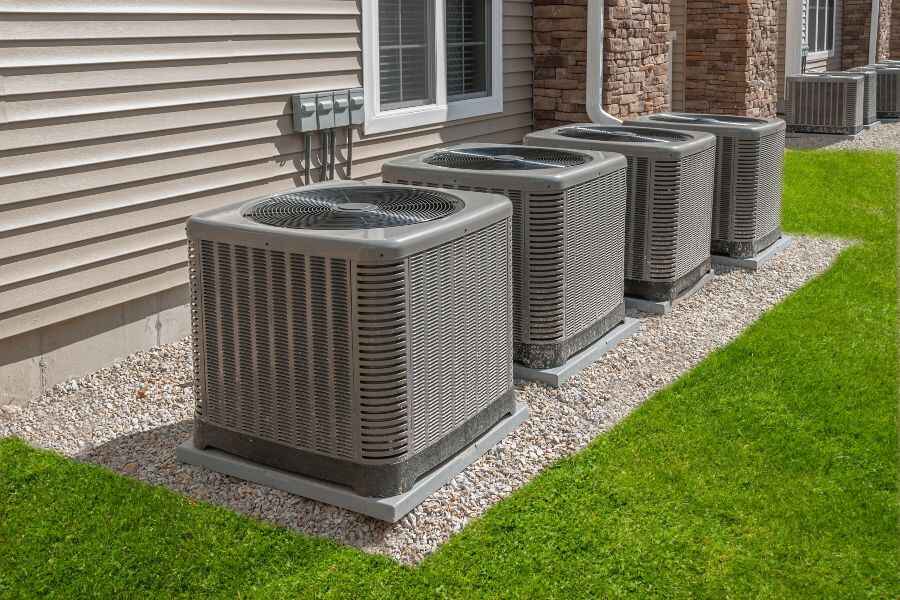 Central air conditioning unit with large outdoor compressor for whole-house cooling.