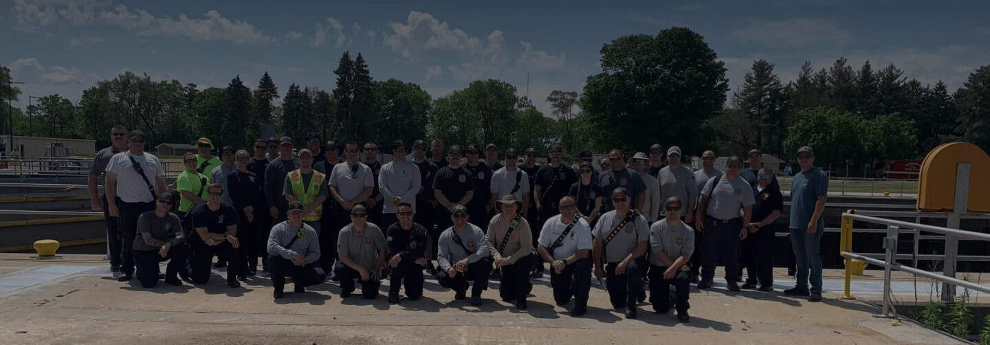 Large group of workers outdoors at industrial facility