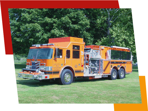 Bright orange fire truck parked on green grass