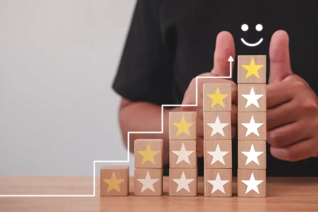Thumbs up with five-star wooden blocks symbolizing excellent IT AMC services in Dubai