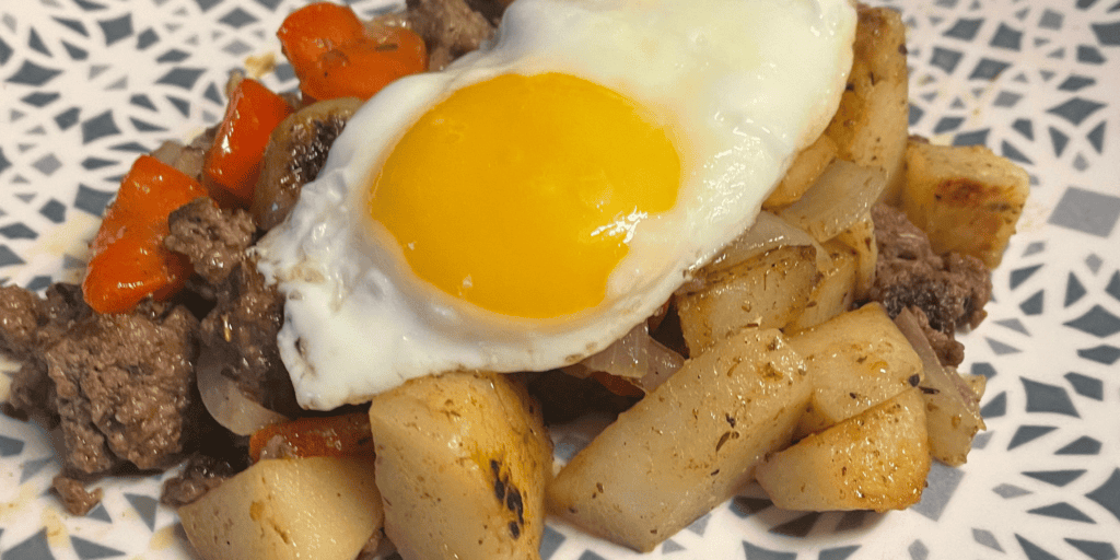 fried egg on hamburger potato hash