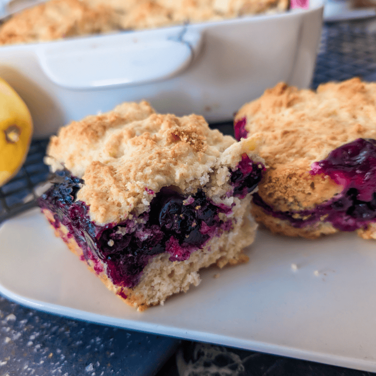Close-up of blueberry lemon crumble squares with golden crust and vibrant berries.