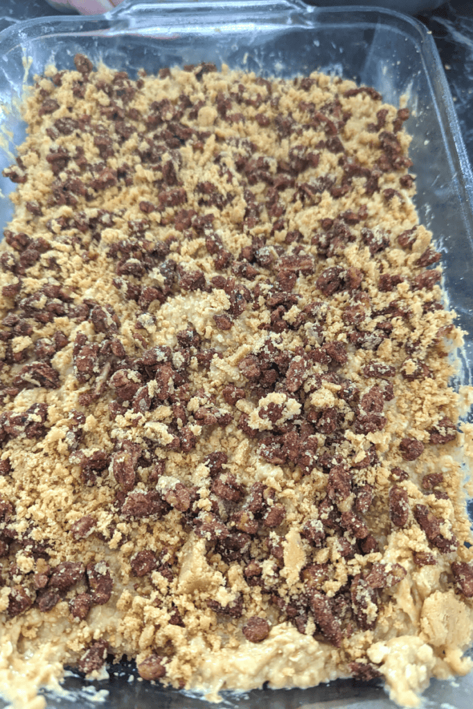 Spread candied pecans streusel topping over the entire cake surface