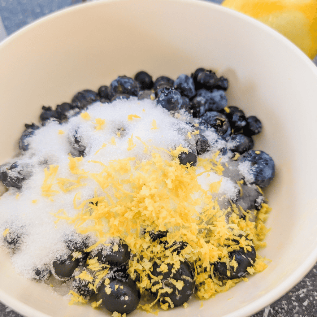 Fresh blueberries with lemon zest and crumble topping.