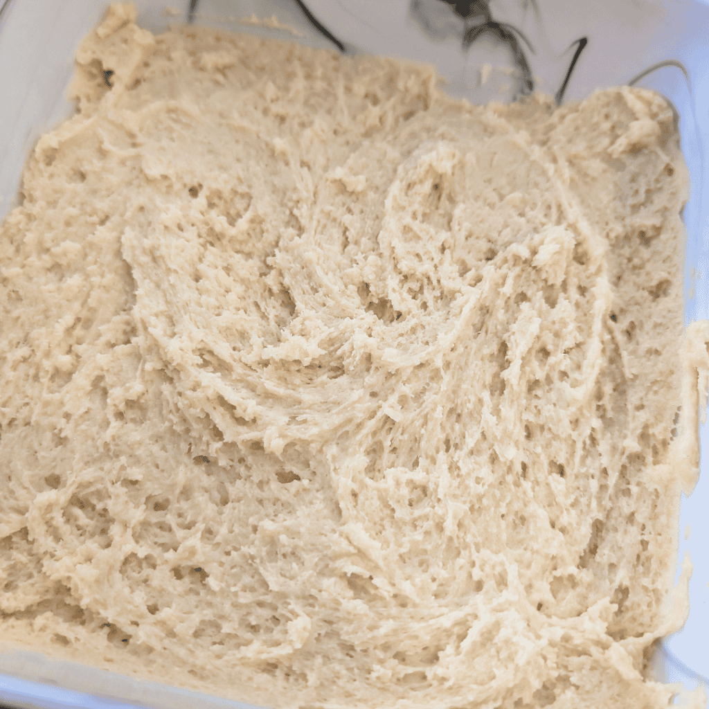 Close-up of a creamy blueberry lemon crumble square base in a baking dish.