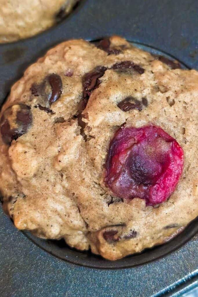 close up of a chocolate cherry oatmeal muffin.