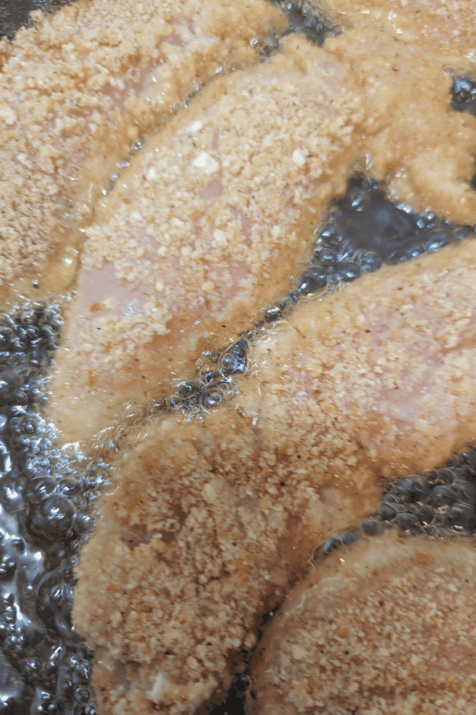 add breaded chicken breast fillets to hot oil