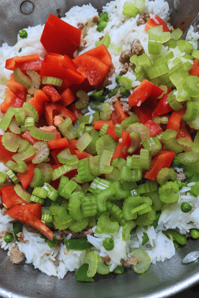 add peppers celery to rice and sausage mixture for dinner