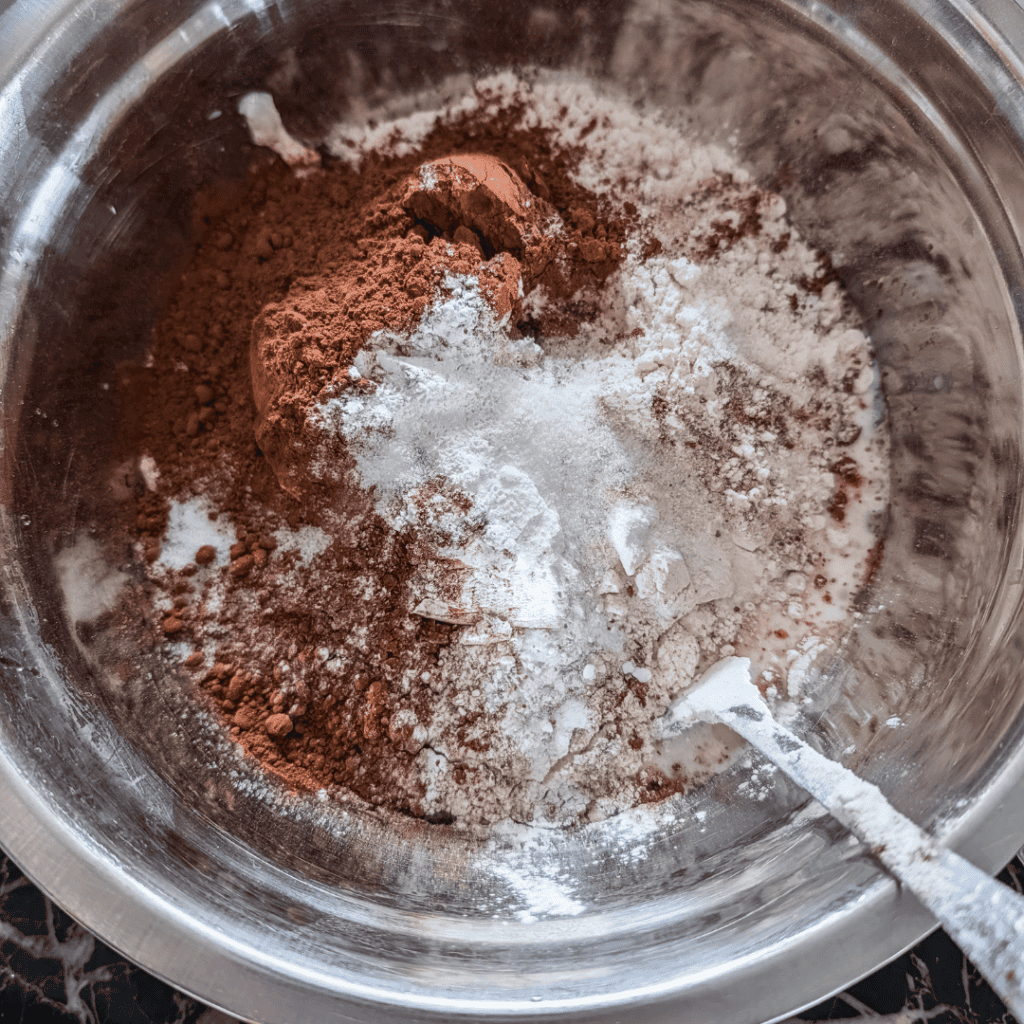 Chocolate and orange muffin ingredients in a mixing bowl.