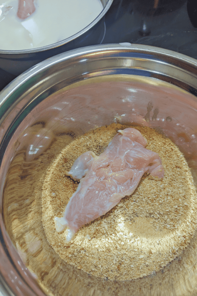 chicken breast dredged in breadcrumb mixture
