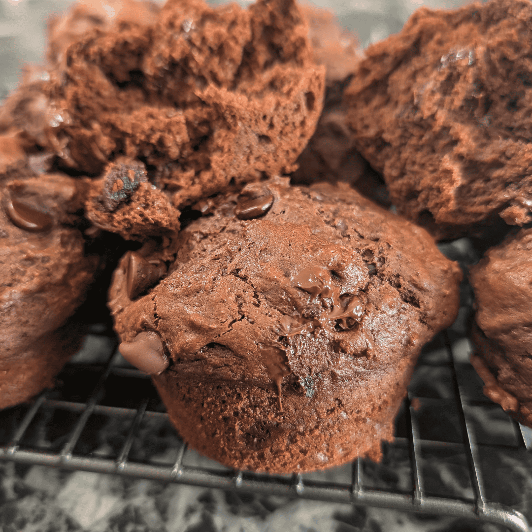Close-up of chocolate orange muffins on a cooling rack, fresh and homemade.