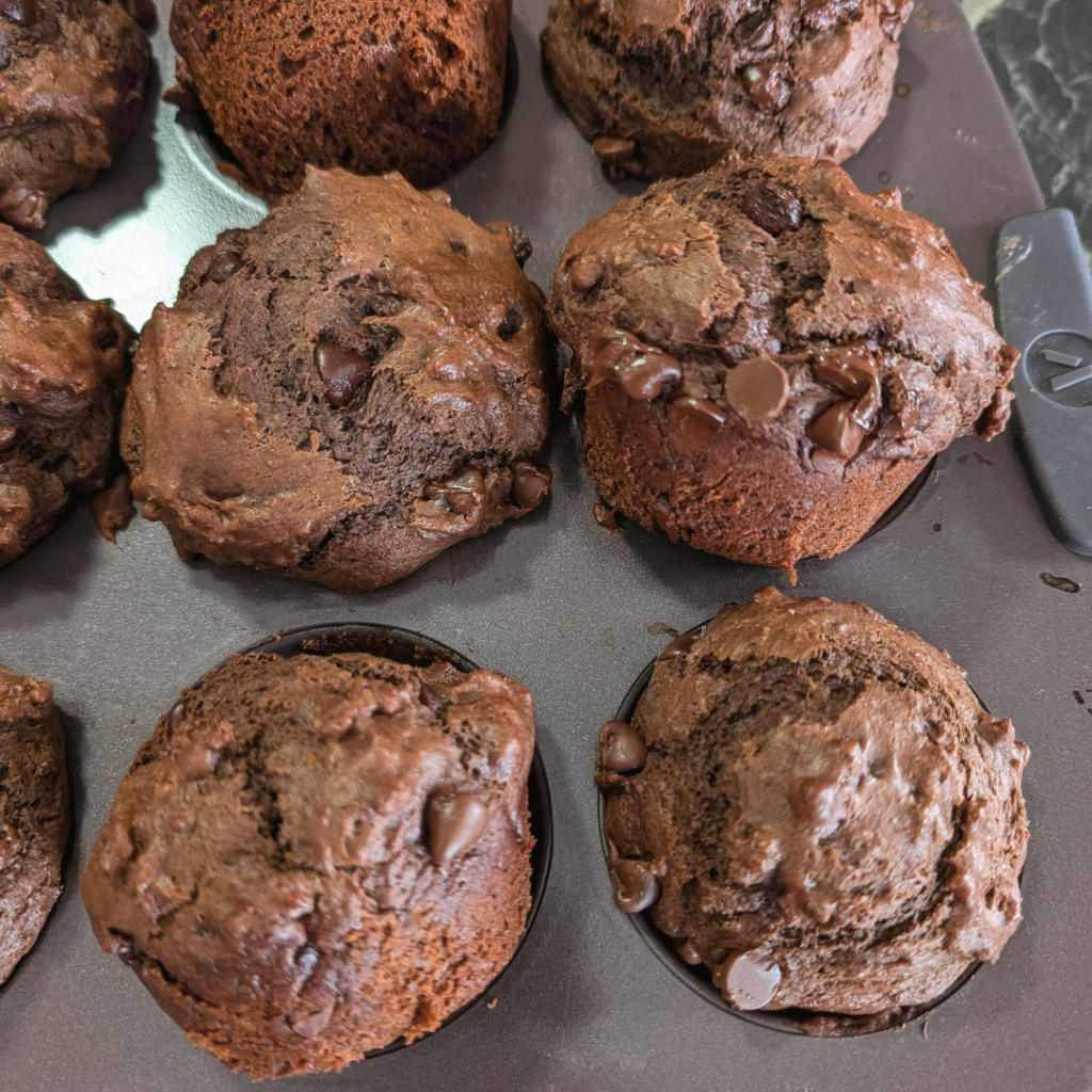 Delicious chocolate orange muffins topped with orange zest, perfect for a sweet treat or breakfast.