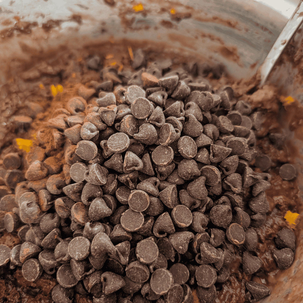 Close-up of chocolate chips in muffin batter for Chocolate Orange Muffins.