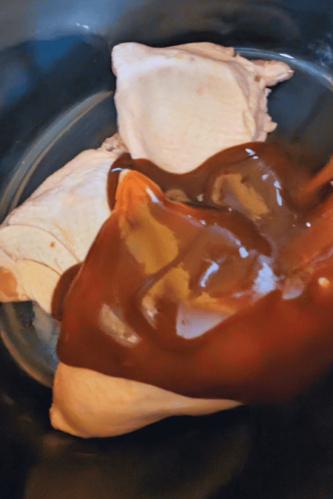 adding bbq sauce to chicken thighs