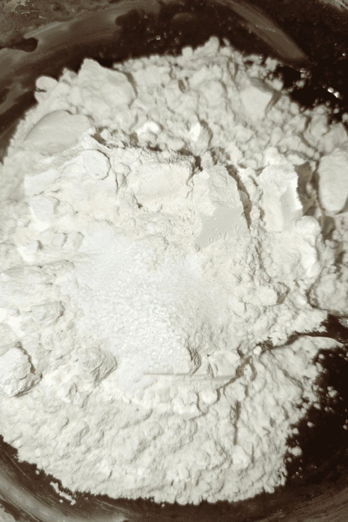 adding dry ingredients to muffin batter