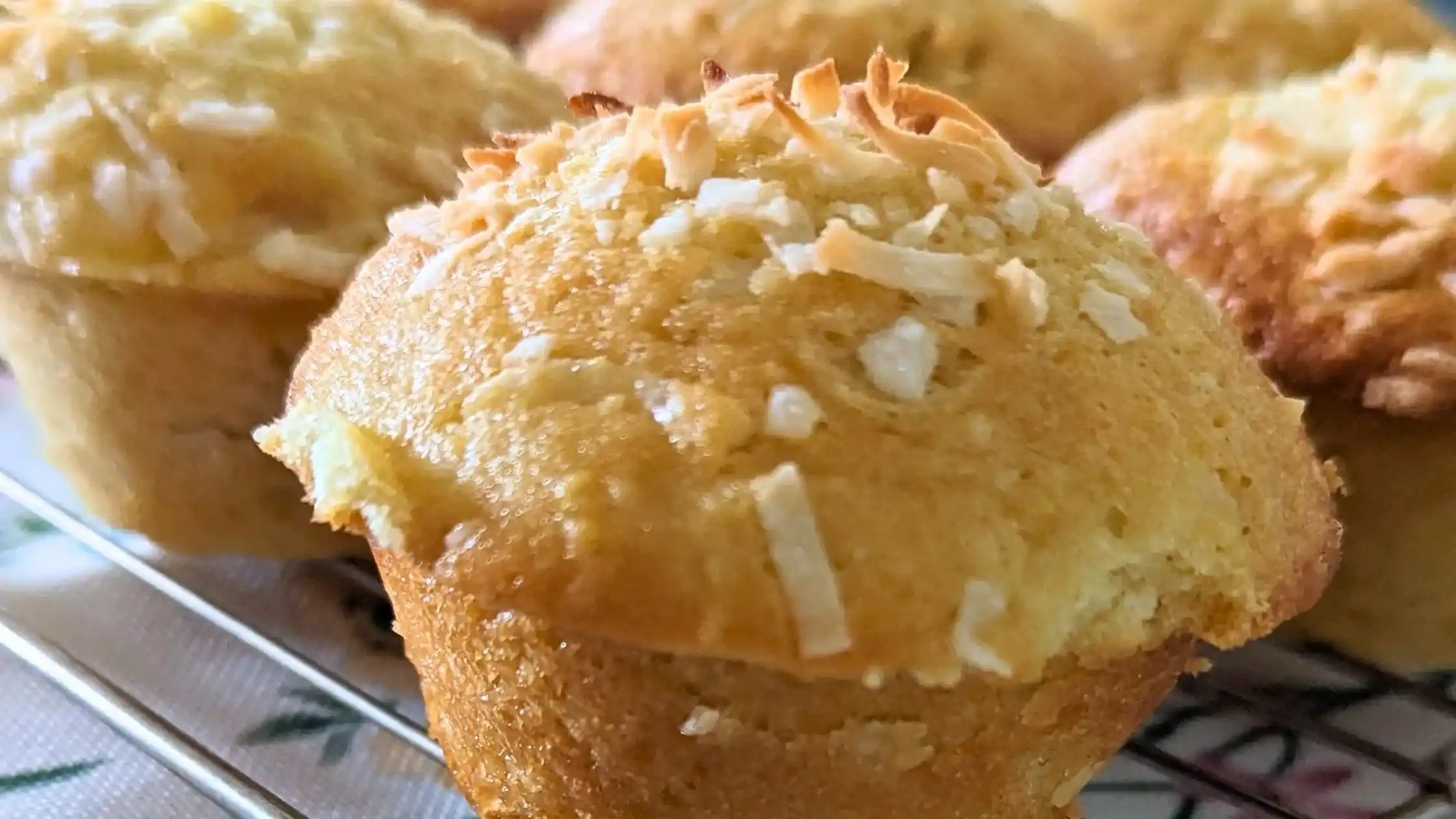 the featured image of peach coconut muffins on a wire rack