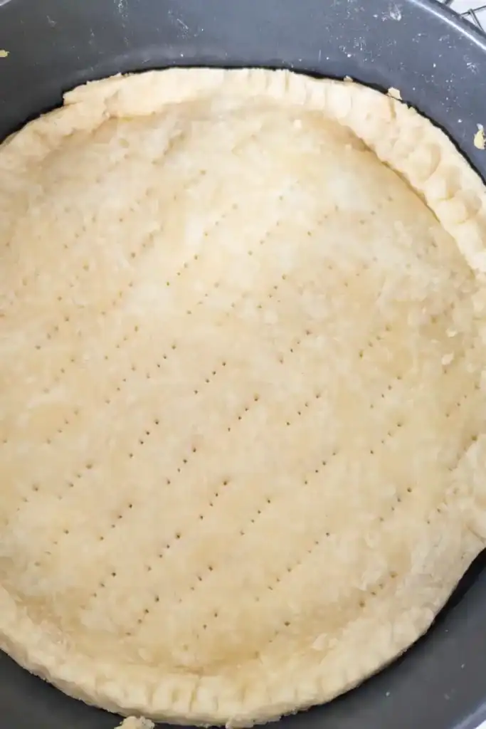 docking the tart shell in a springform pan