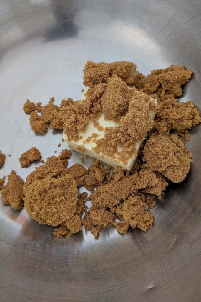adding brown sugar to butter in mixing bowl