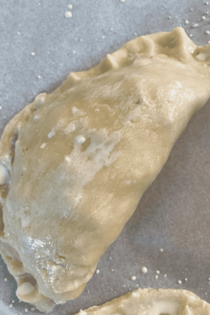 fold over pastry crimp edge and brush with cream