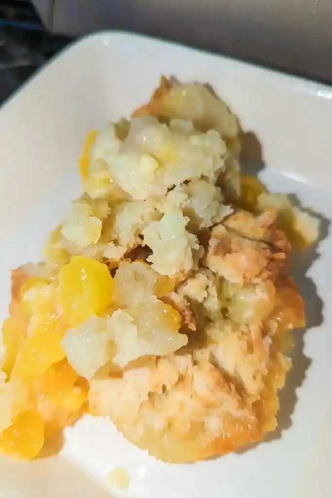 the peach cobbler in a white porcelain dish
