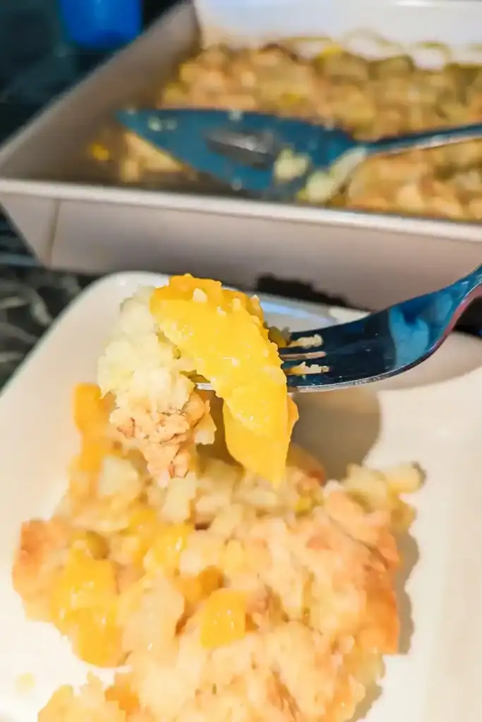 lifting a slice of peach with more of the baking pan and lifter seen in background
