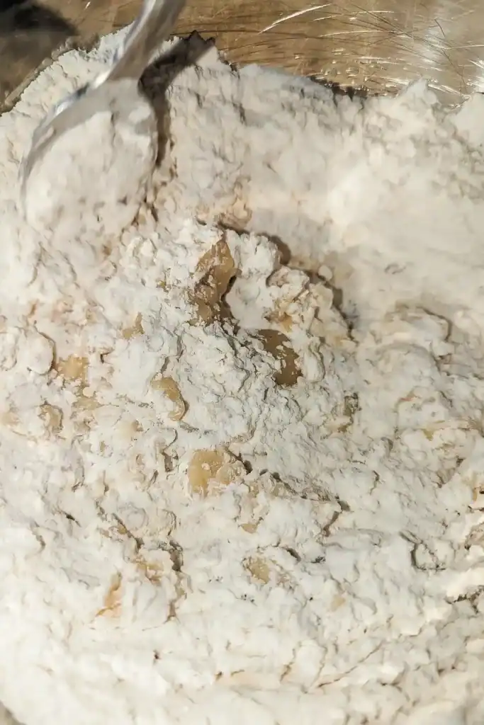 adding the milk to the biscuit mixture