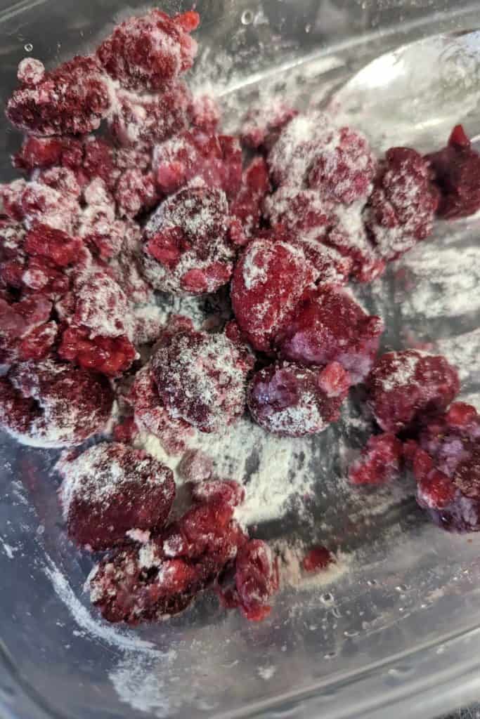 dust frozen raspberries with flour