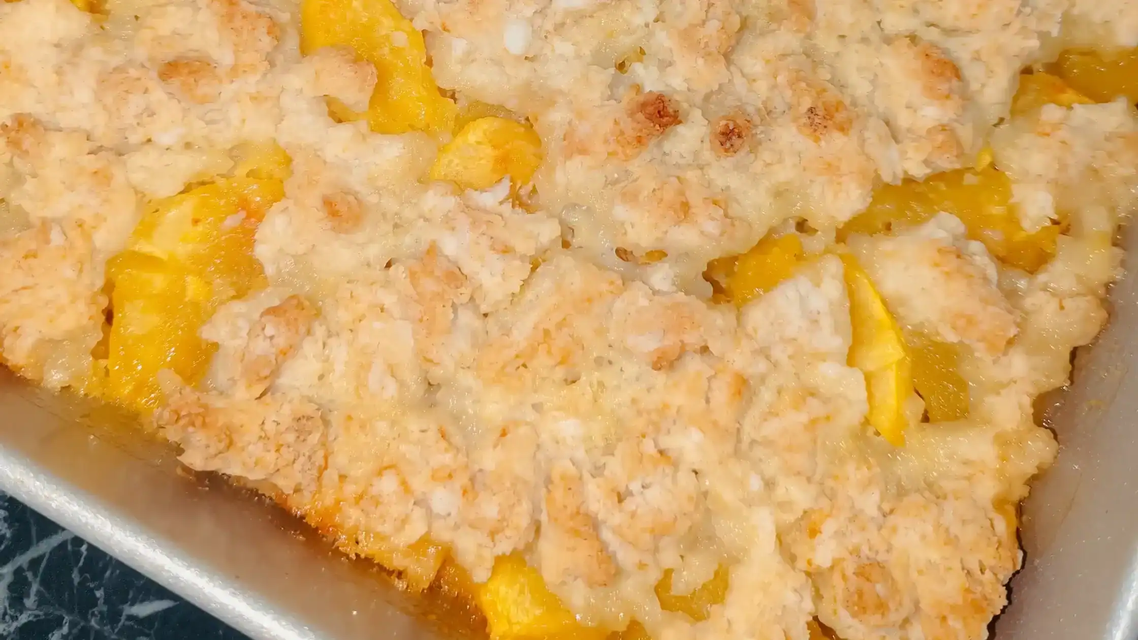featured image baked peach biscuit cobbler top view