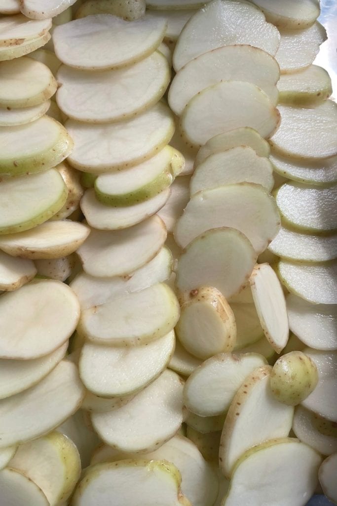 thin sliced new potatos layered