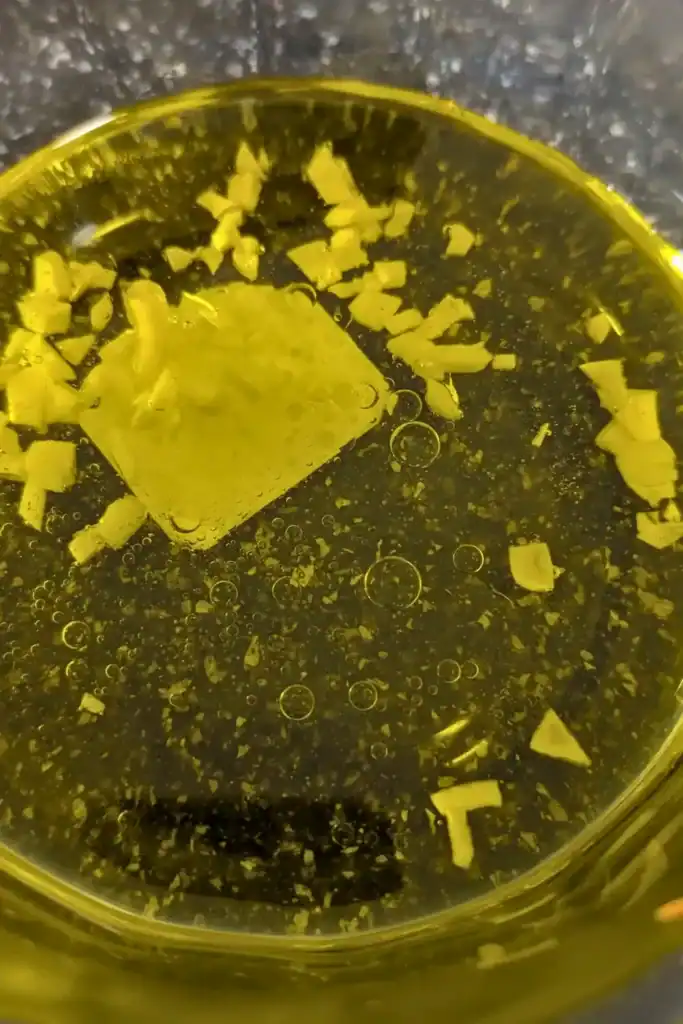 mixing the salad oil with fresh chopped garlic in glass bowl