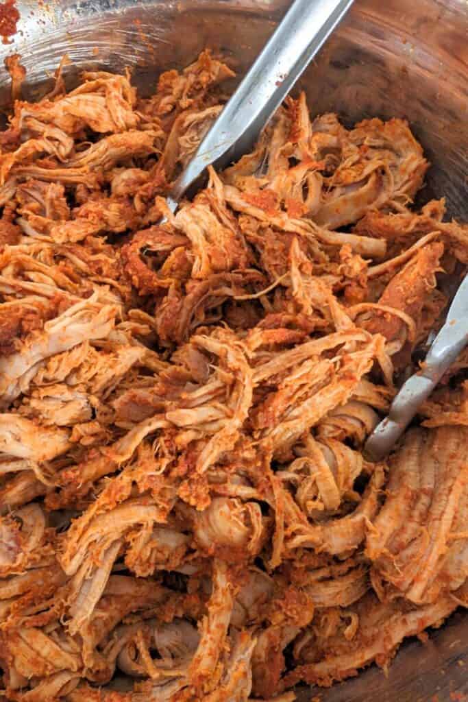 add reserved juices back into pull pork tenderloin and add to bowl