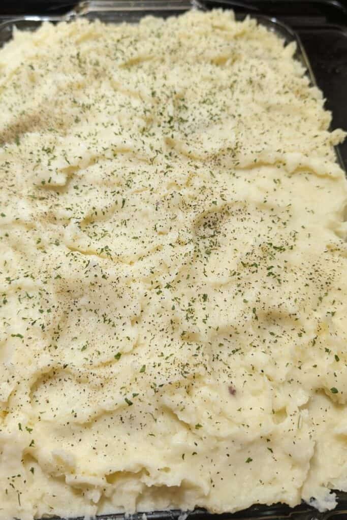 adding dry parsley and pepper shepherds pie