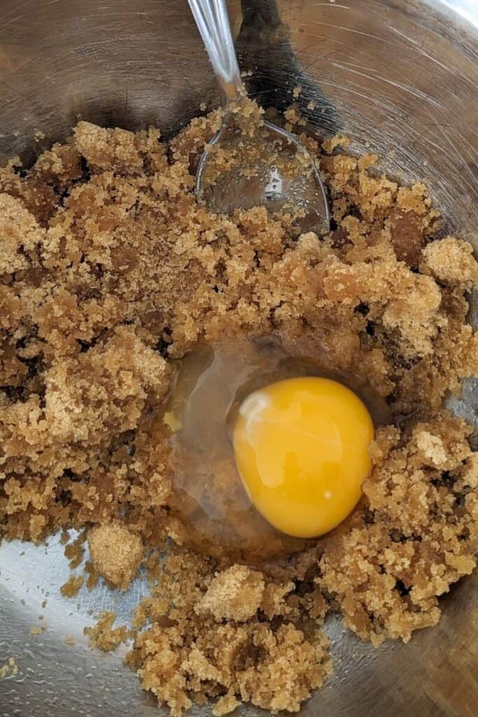 adding egg to oil and sugar blend