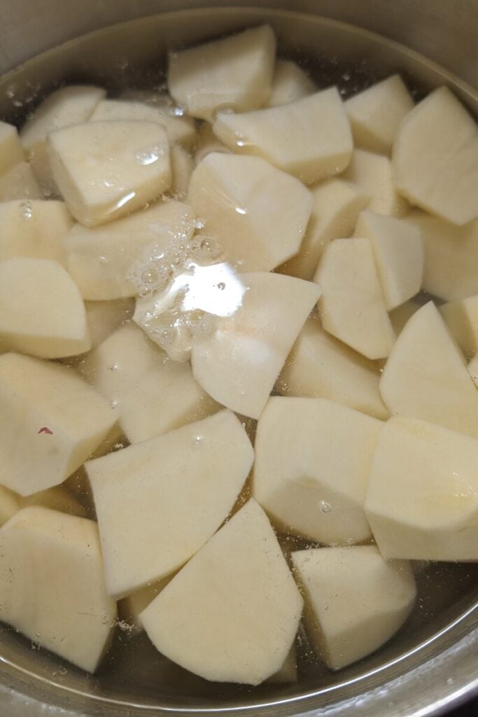 cut potatoes for mashed potato in water