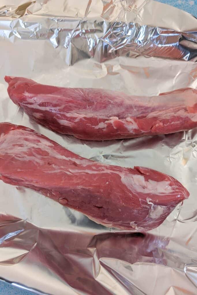 lay pork tenderloin onto the tin foil in baking pan
