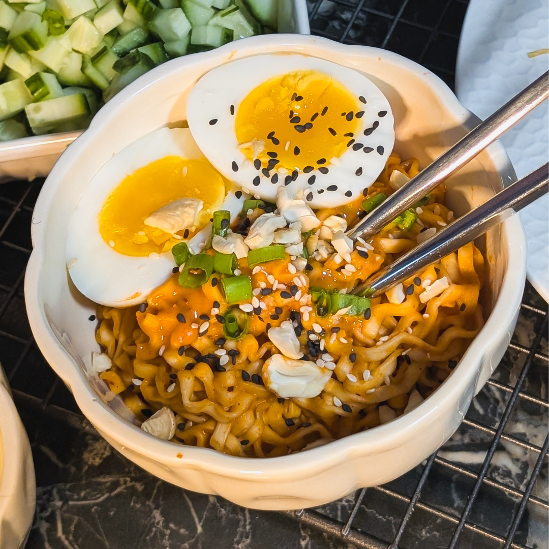 Delicious spicy peanut instant noodles topped with soft-boiled jammy eggs and fresh green onions. Pe.