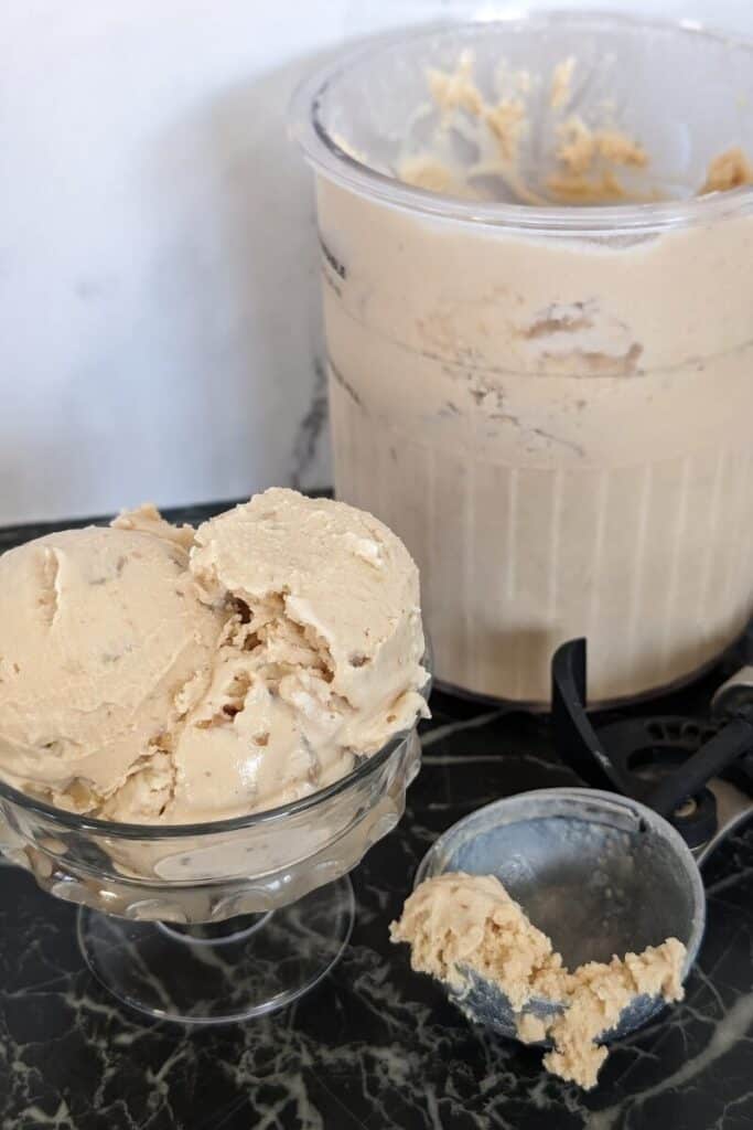Ninja creami maple walnut ice cream in glass dish ice cream scoop and pint nearby