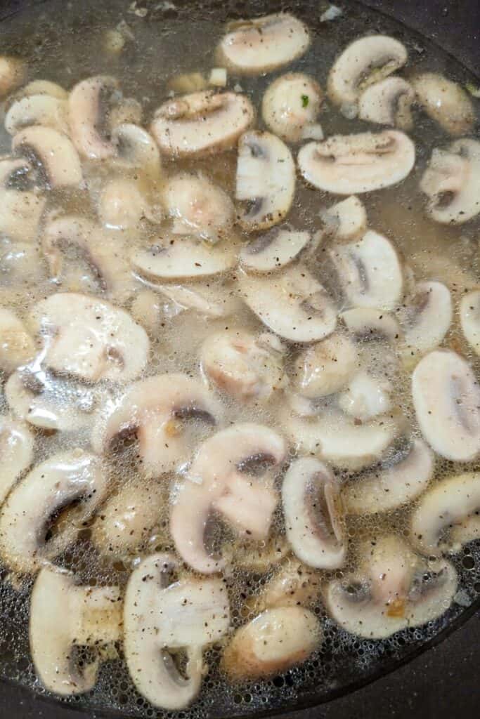 ADDING cornstarch slurry to chicken stock mushrooms garlic in fry pan
