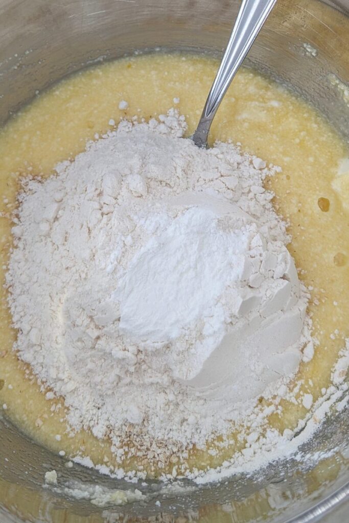 adding dry ingredients to cookie dough