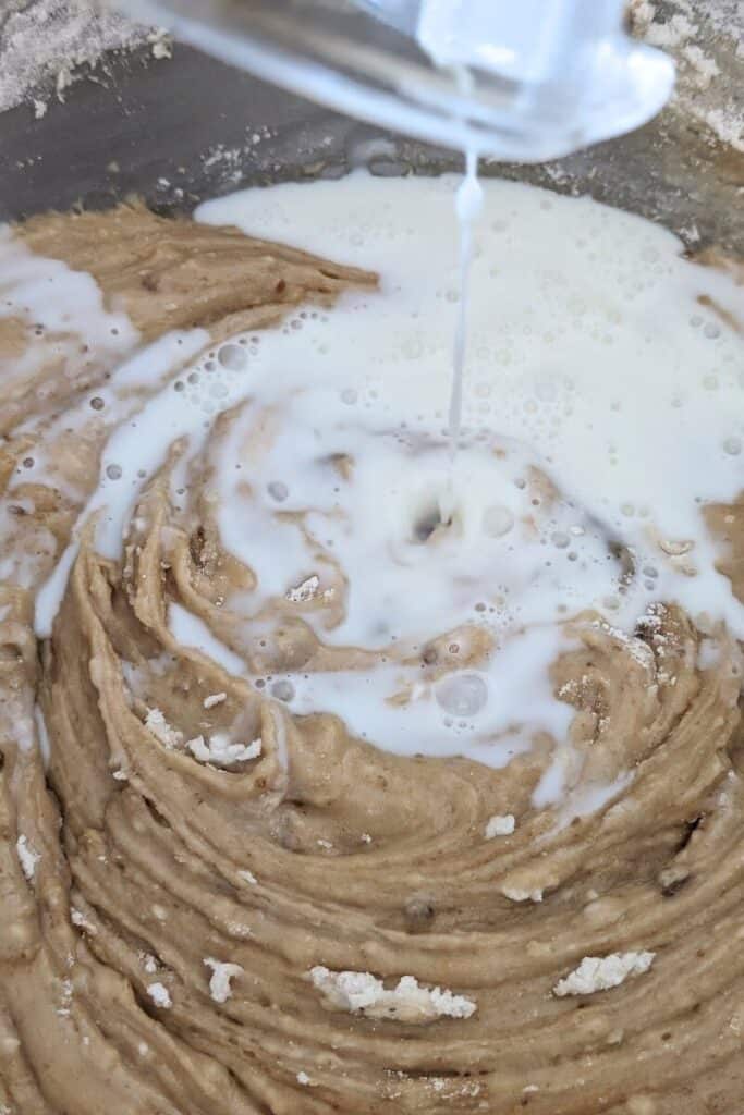 adding remaining milk to cake batter