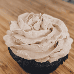 Delicious homemade flavored Cool Whip frosting topped on a chocolate cupcake. Perfect for decorating.