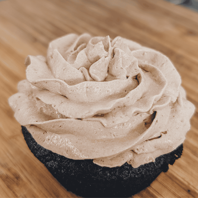 Delicious homemade flavored Cool Whip frosting topped on a chocolate cupcake. Perfect for decorating.