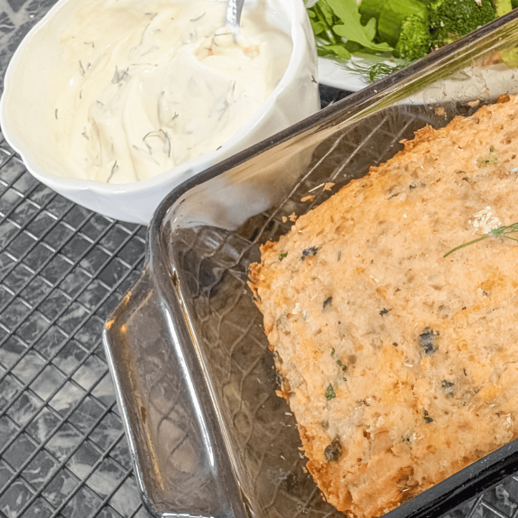 Delicious homemade fish pie with creamy sauce and herbs in a glass baking dish.