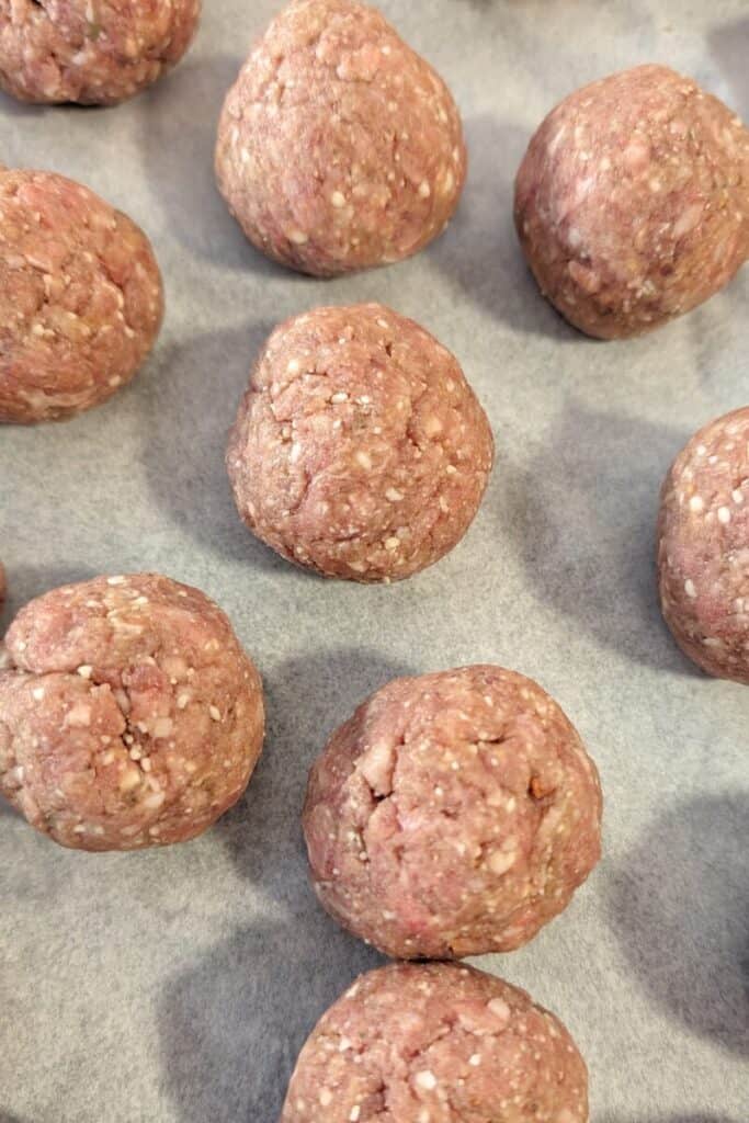 forming meatballs on parchment paper