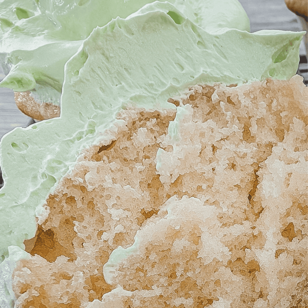 Delicious homemade flavored Cool Whip frosting with a light, fluffy texture and mint-green color. Pe.