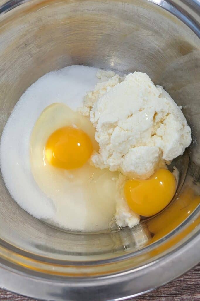 ricotta cheese eggs sugar in mixing bowl