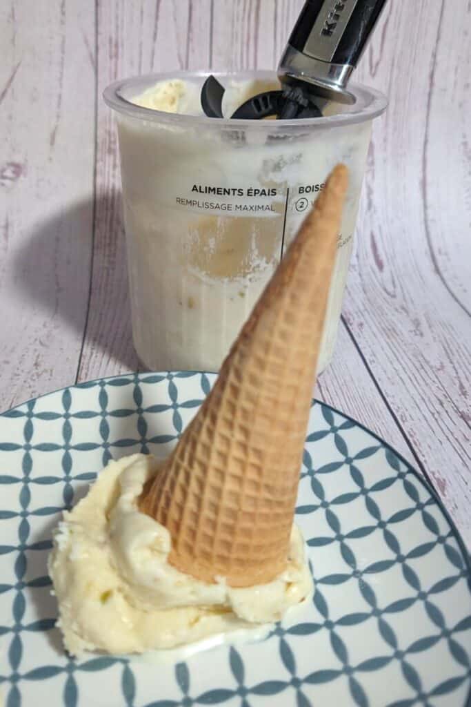 pistachio ice cream sugar cone upside down with pint in back