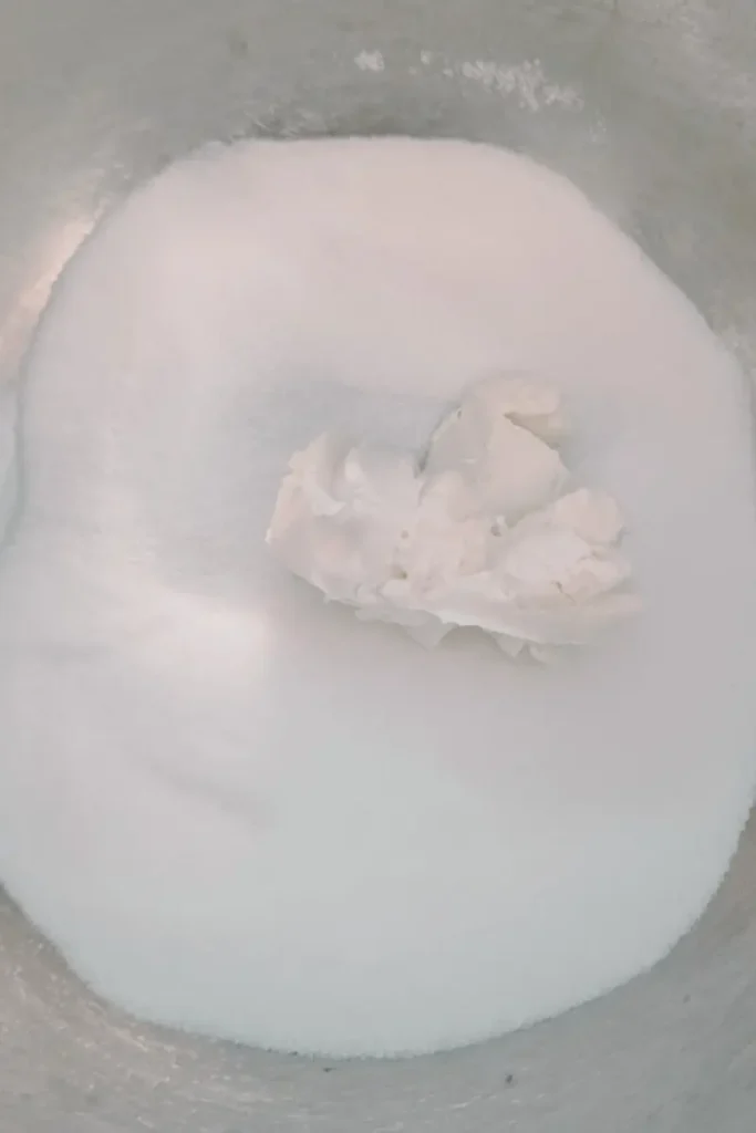 adding white sugar to cream cheese