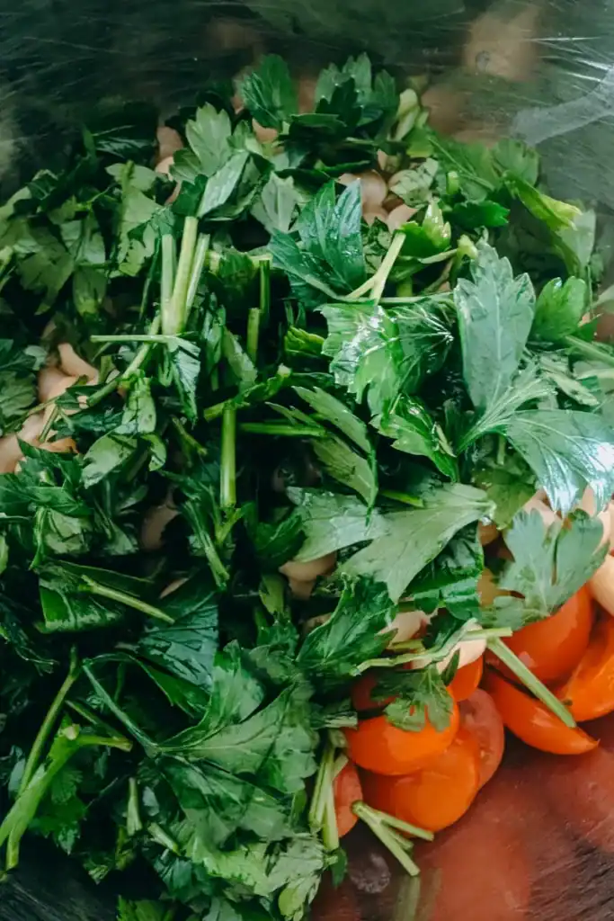 adding fresh parsley to salad